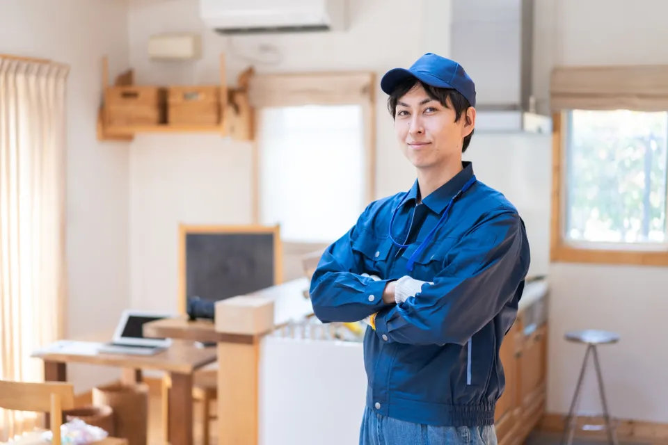 Uniformed technician standing with arms crossed