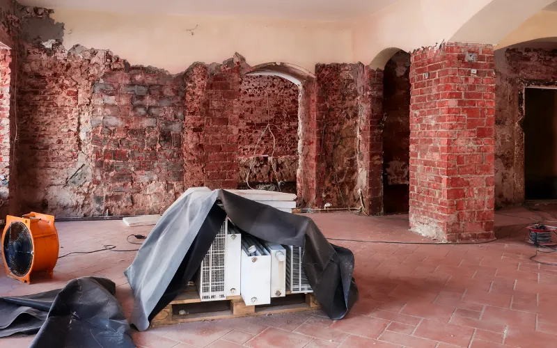 Room with exposed brick walls during renovation