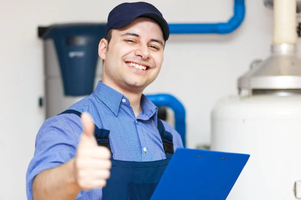 Smiling technician with a clipboard giving a thumbs-up